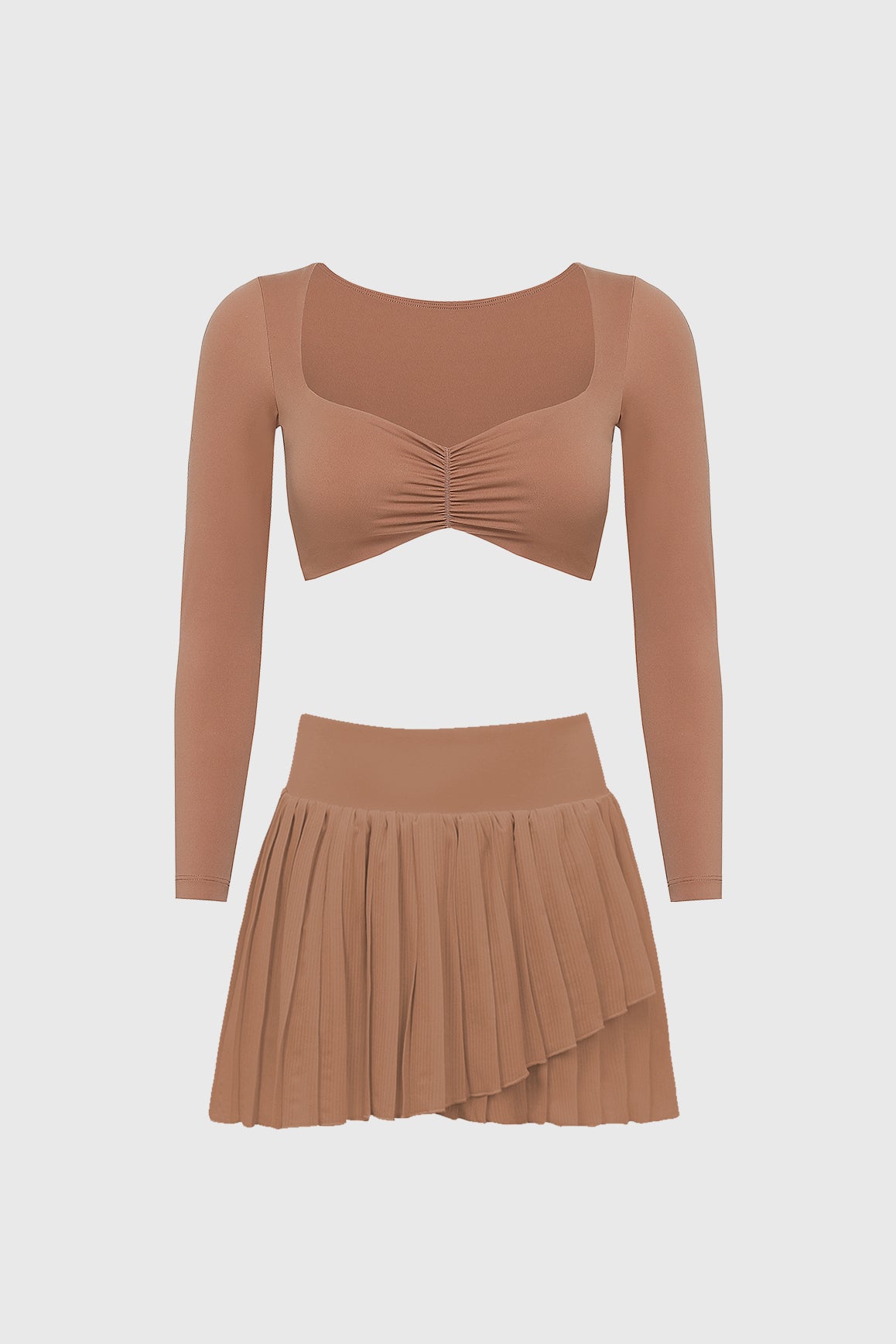 WISKII long sleeve ruched bra and pleated skirt bundle in cinnamon, featuring a fitted top and elegant, flowing skirt.