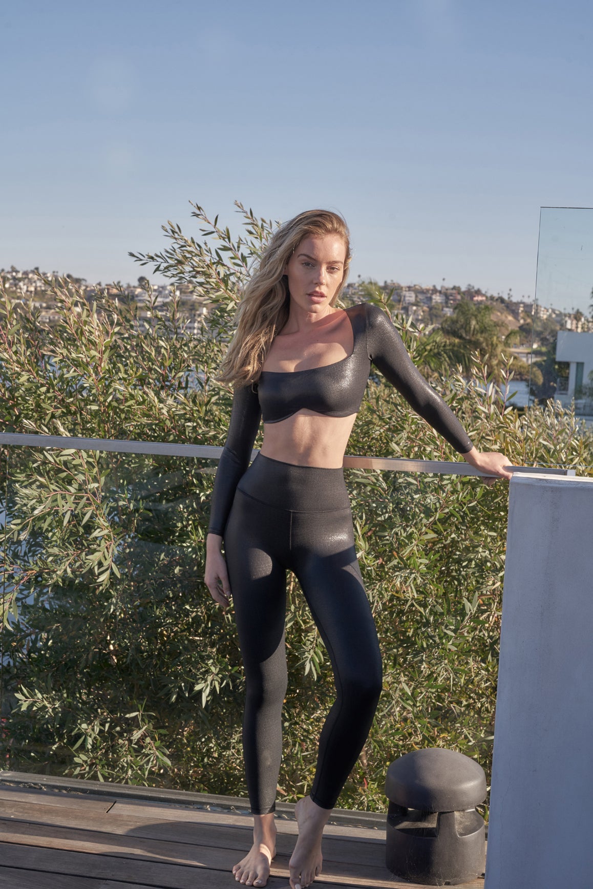 Black faux leather long sleeve crop top bra by WISKII, stylish and fitted for modern fashion looks.
