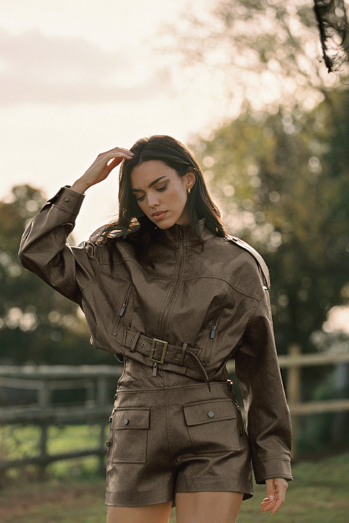 WISKII faux leather overall shorts in taupe, featuring a stylish, structured design with adjustable straps and front pockets.