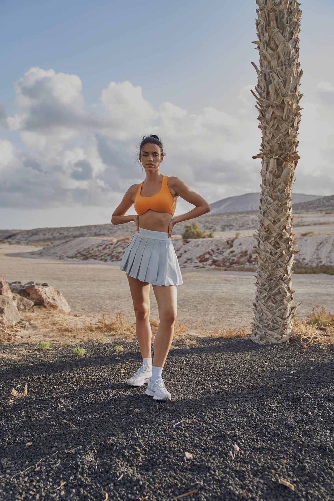 Ivory A-line pleated skirt from WISKII, showcasing a flowy, elegant design with soft pleats and a comfortable waist.