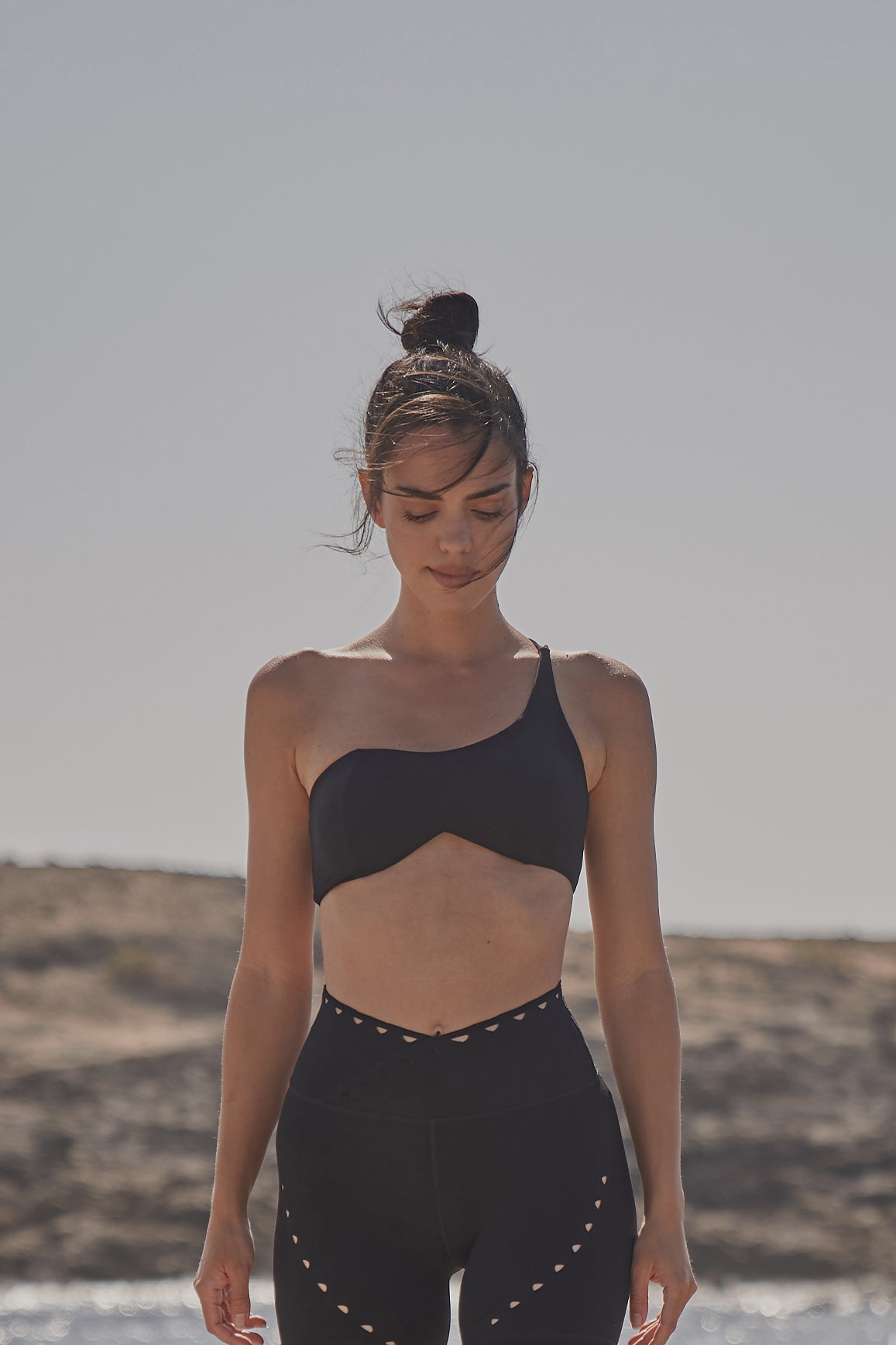 Black WISKII one shoulder contour sports bra with supportive design and sleek fit, ideal for activewear and workouts.
