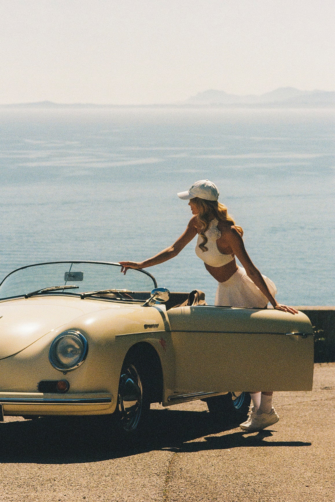 Model wears Riviera Floral Halter Mock Neck Top and Mini Bubble Skirt | Ivory | WISKII Active