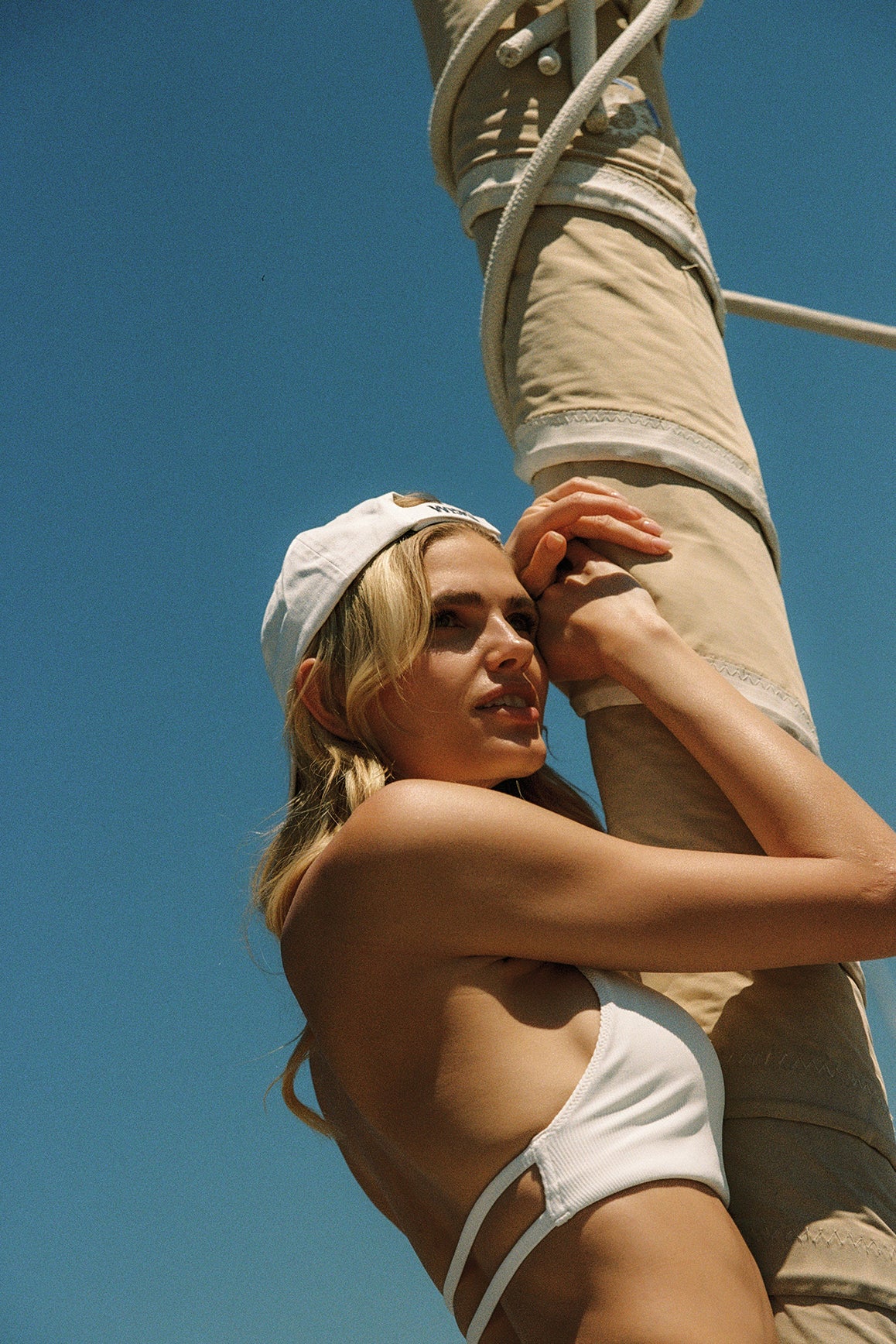 Model wears Riviera Floral Halter Mock Neck Top and Mini Bubble Skirt | Ivory | WISKII Active