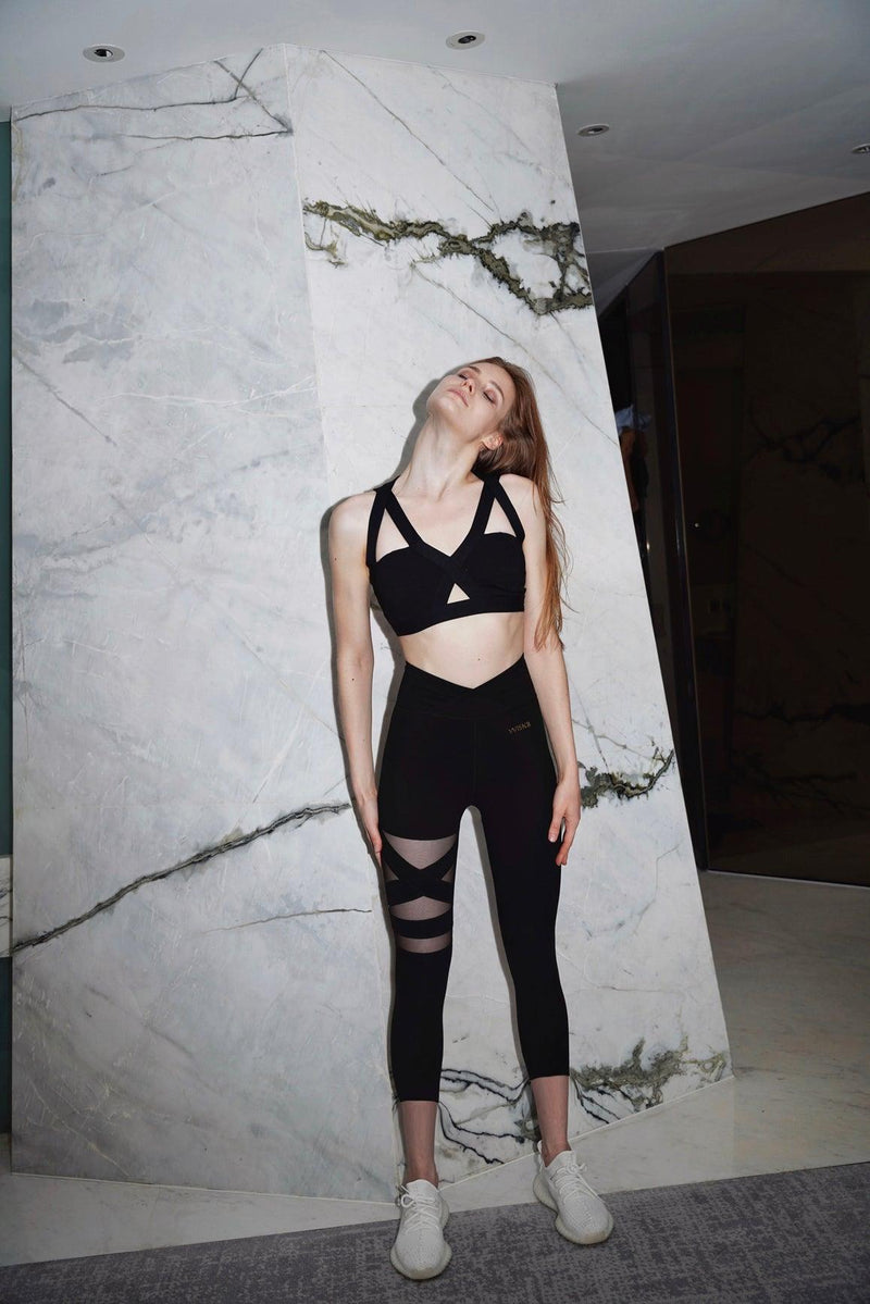 a model wears a WISKII 6/8 training mesh leggings doing a post